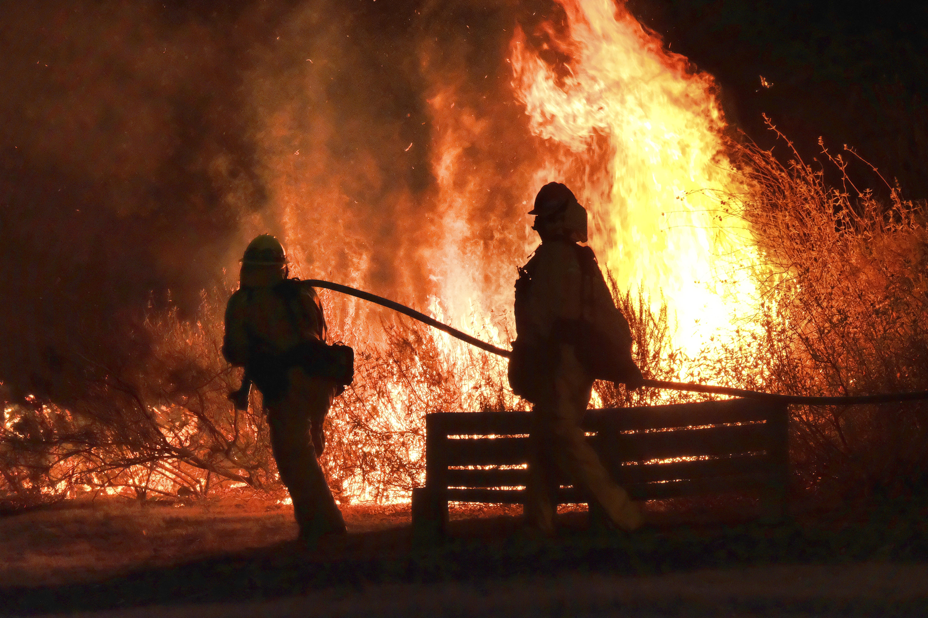 Some evacuations lifted as crews fight California brush fire